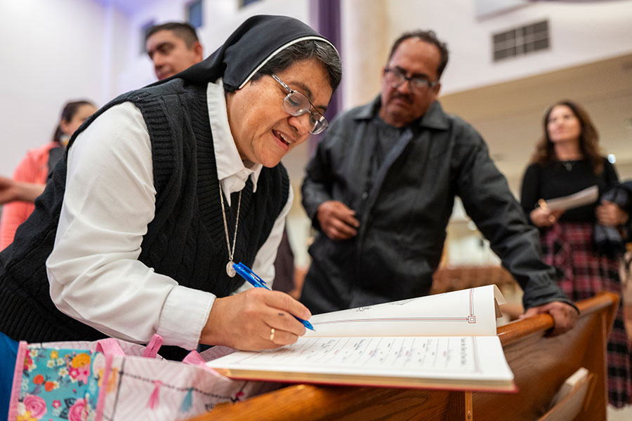 Sister Silvia signs the Book of Election